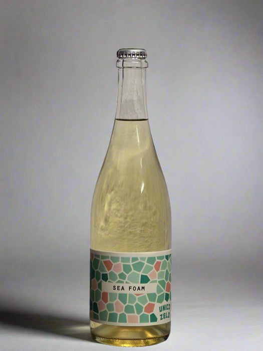 Bottle of 'Sea Foam' wine with a patterned label on a gray background